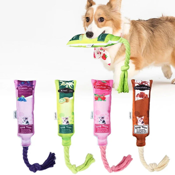 Corgi playing with colorful dog toys shaped like jam bottles with rope tails, perfect for chewing and tugging.