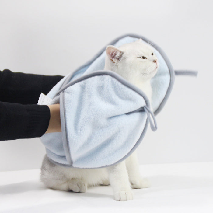 White cat wearing a soft light blue fleece pet recovery cone for comfort.