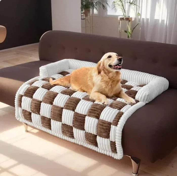 Golden retriever resting on checkered dog bed on sofa, cozy pet furniture for home