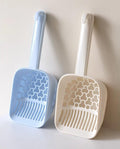 Blue and white cat litter scoops with honeycomb design for easy cleaning and pet care essentials