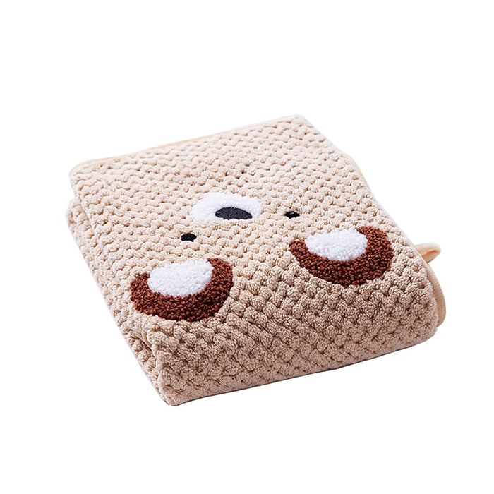 Folded beige plush pet blanket with a cute bear face design.