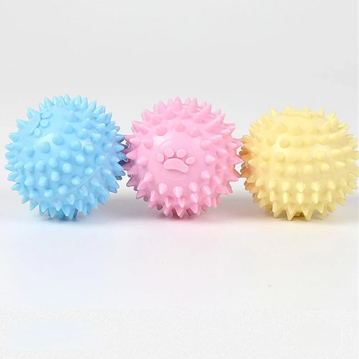 Colorful spiky dog chew toys in blue, pink, and yellow for pet play and dental care
