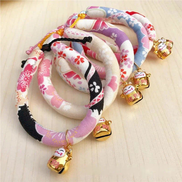 Floral patterned pet collars with lucky cat charms, ideal for cats and small dogs