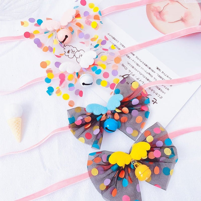 Colorful polka dot pet hair bows with bells and butterfly accents for dogs and cats.