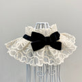 Elegant white lace pet collar with a black velvet bow accessory.