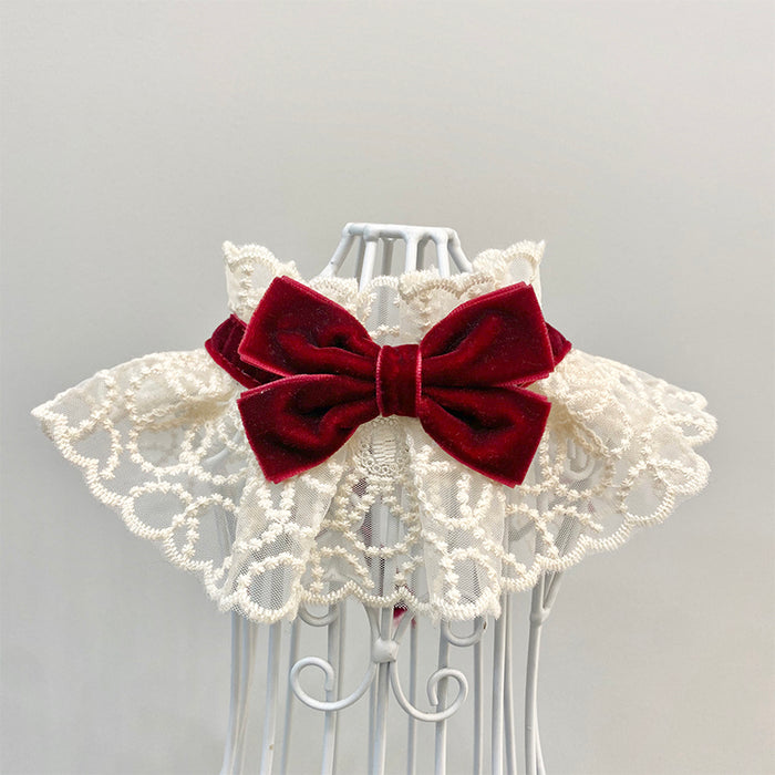 Elegant cream lace pet collar with a deep red velvet bow accessory.