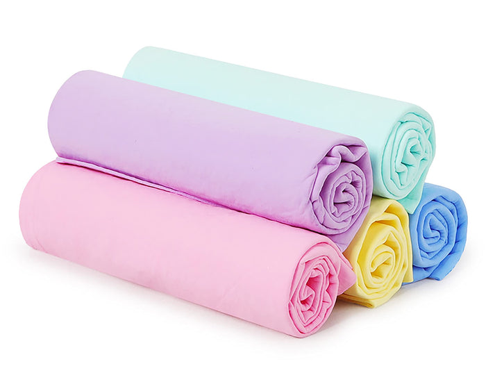 Rolled pastel colored pet blankets in pink, purple, mint, yellow, and blue.