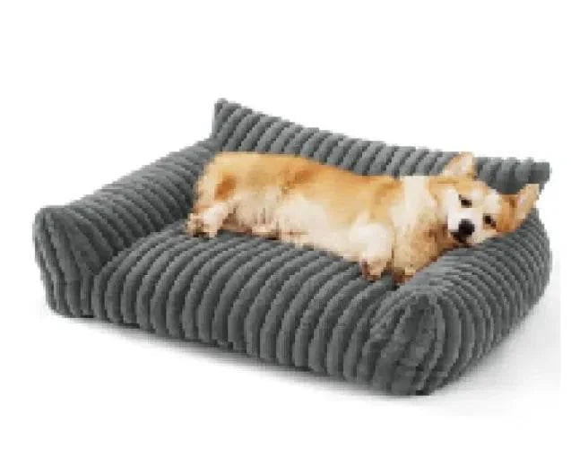 Cozy corgi resting on a plush gray dog bed, perfect for pet comfort and care.