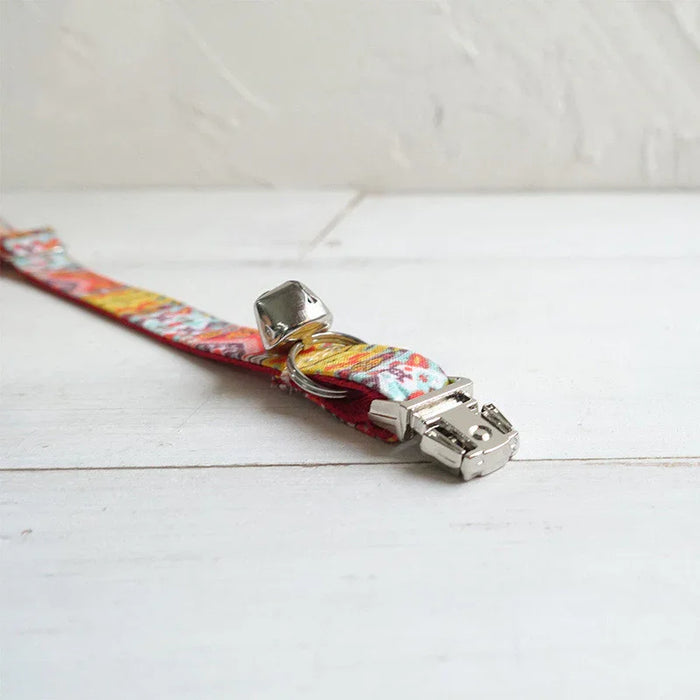 Colorful patterned cat collar with silver bell and buckle, ideal for pet safety and style