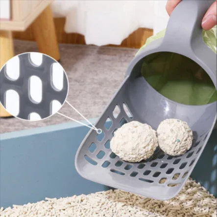 Gray cat litter scoop with oval holes, lifting clumps from litter box, ideal for pet care essentials.