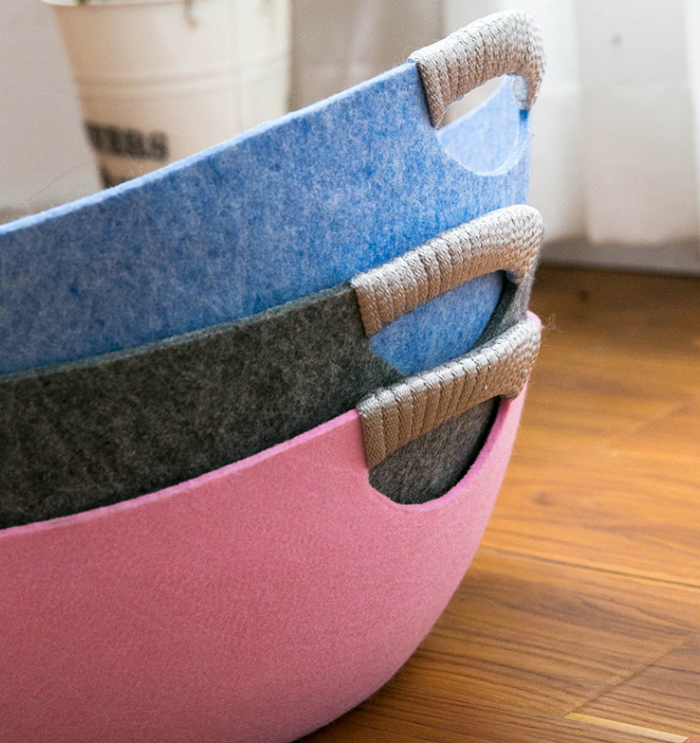 Stacked felt storage baskets in pink, gray, and blue with rope handles for pet supplies organization