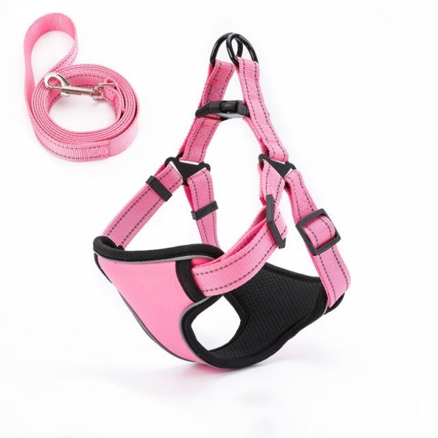 Pink dog harness with matching leash, adjustable straps, and black padding for comfort